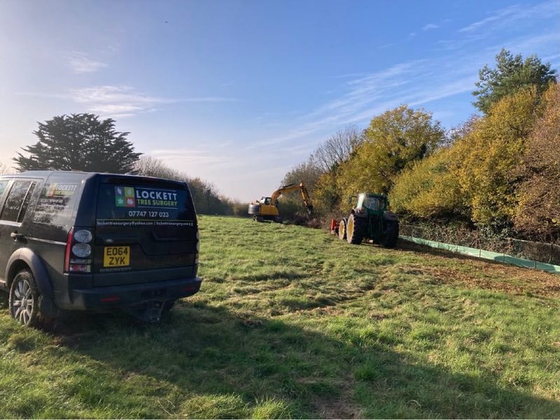 Lockett Land Rover, excavator and tractor working on a clearance site