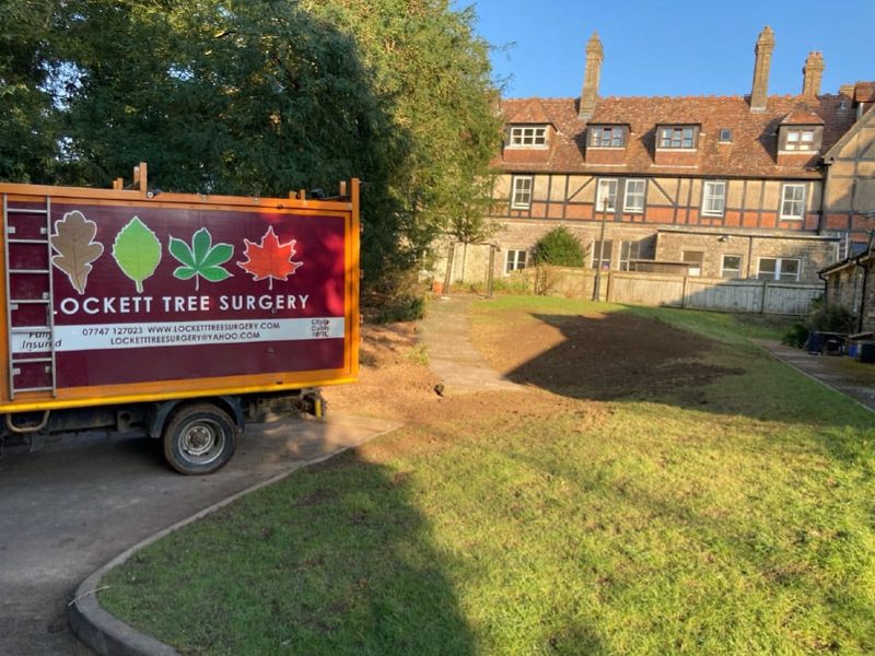 Lockett truck beside a tidy cleared garden at the end of a removal