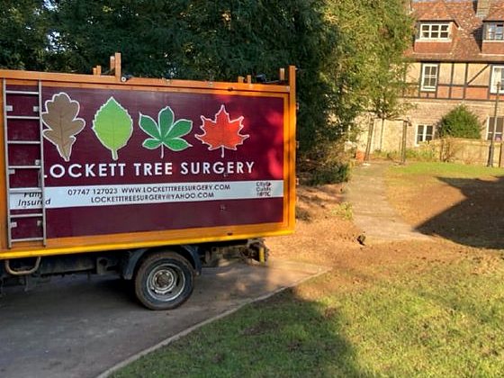 Lockett Tree Surgery truck parked at a finished, tidy job